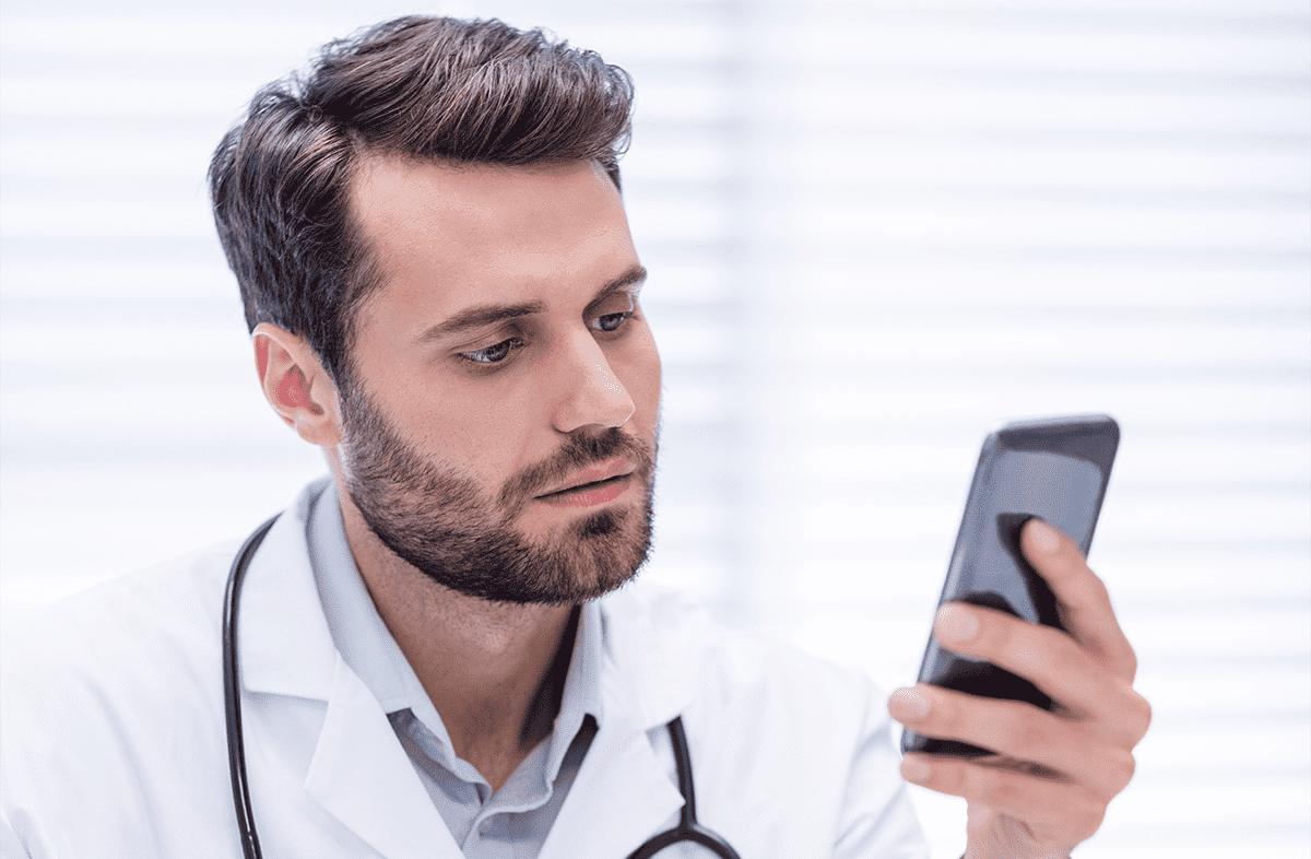 A healthcare professional using their cellphone.