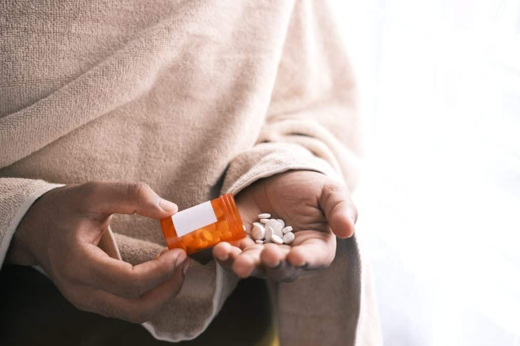 Prescription pills in a woman's hand