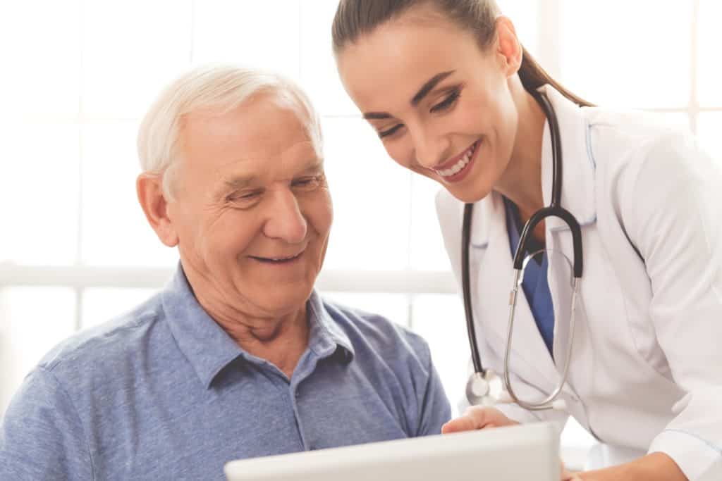 A patient and a doctor look at a tablet