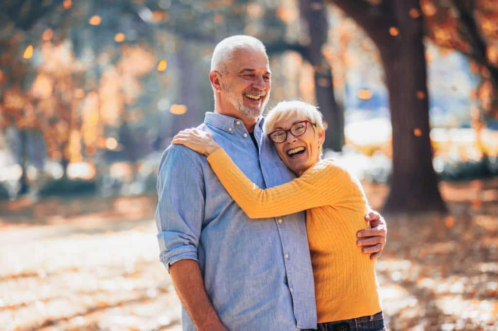 Older couple embracing and smiling