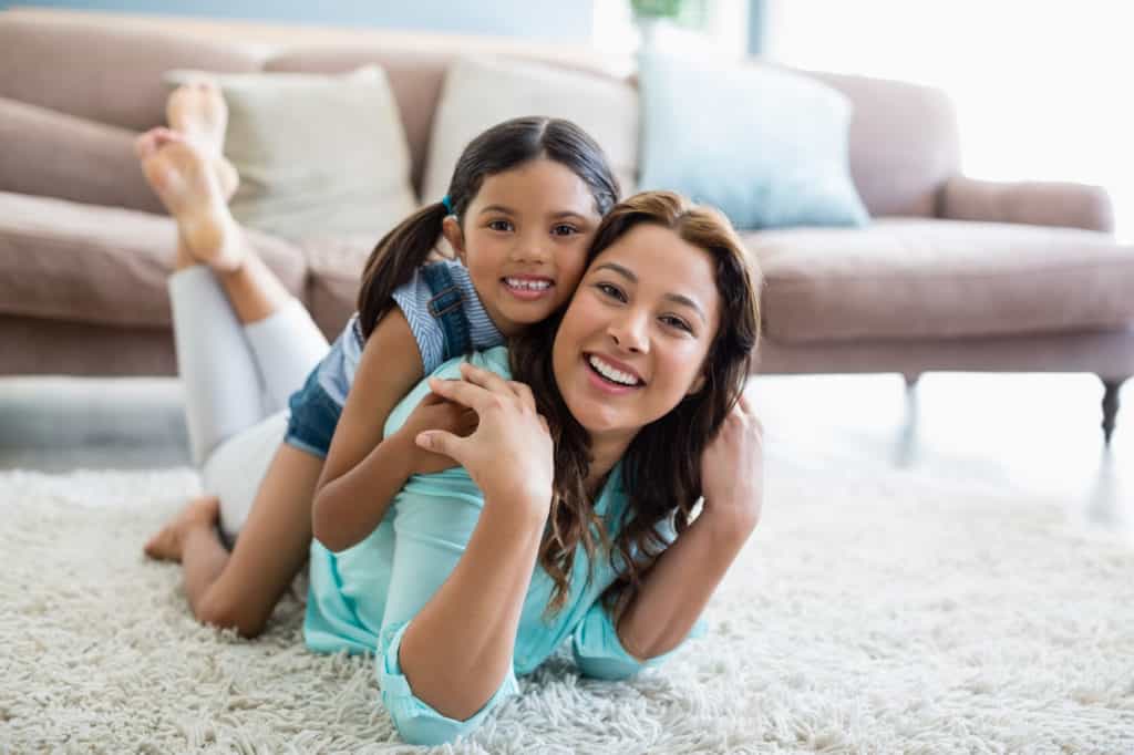 Mother and daughter smiling