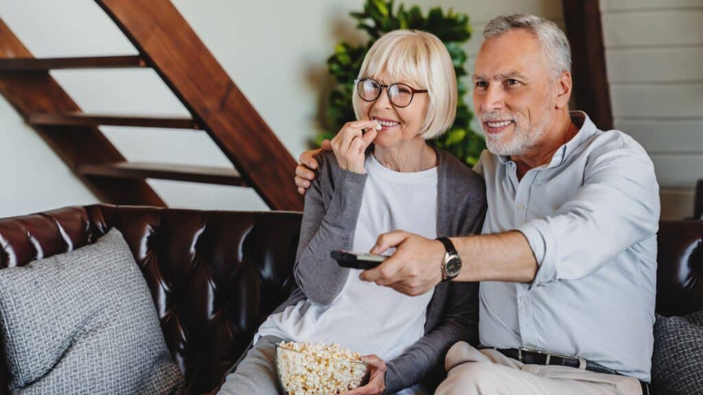 senior couple watching TV